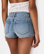 Mini-short en jean taille basse avec clous et étoiles